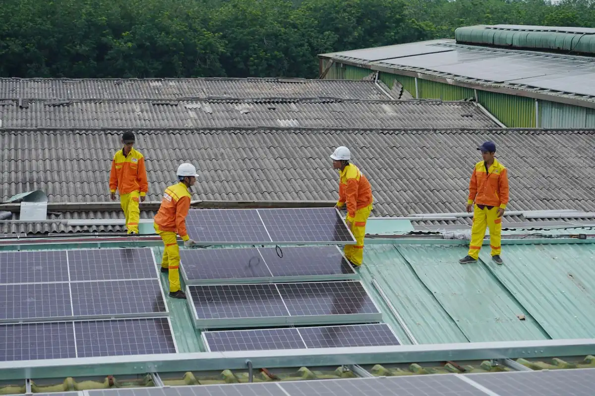 Technician installing rooftop solar panels